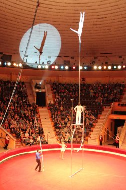 Gomel / Belarus - May 20, 2018 : Circus number. Man equilibrist showing tricks during performance of gymnasts in circus. Gymnasts equilibrists under circus dome