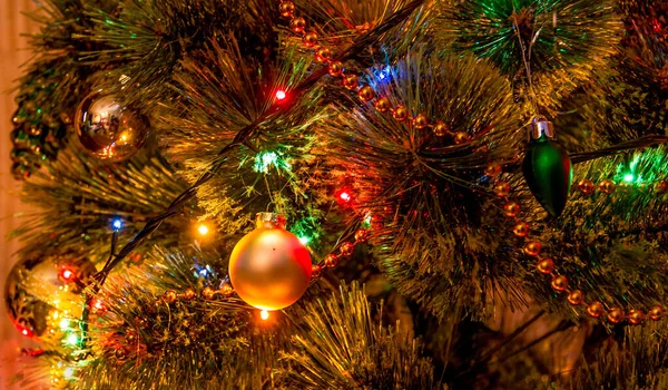 Украшенная елка на размытом, сверкающем и сказочном фоне, блестящем, сверкающем фоне. Украшенное и освещенное рождественское дерево. Волшебно украшенная ель с — стоковое фото