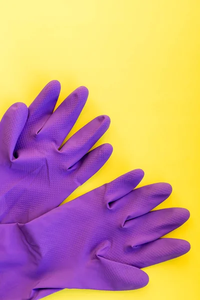 A pair of household rubber gloves isolated on a yellow background.gloves for cleaning . Set of rubber gloves. Composition of protective gloves for cleaning. Variety of protective clothing. — Stock Photo, Image