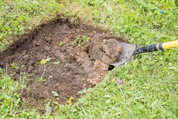 Человек копает садовую лопату в черноземной почве.Фарминг, садоводство, культура и люди - человек с лопатой копает садовую грядку или огород. — стоковое фото