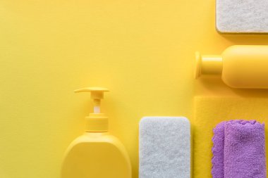 Mutfak, banyo ve diğer odaların farklı yüzeyleri için renkli temizlik seti. Sarı arka planda mesaj ya da logo için boş bir yer. Temizlik hizmeti konsepti. Temizlik. Düzenli temizlik..