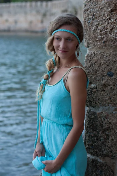 Young blonde woman with braided hear  wearing turquoise dress — Stock Photo, Image