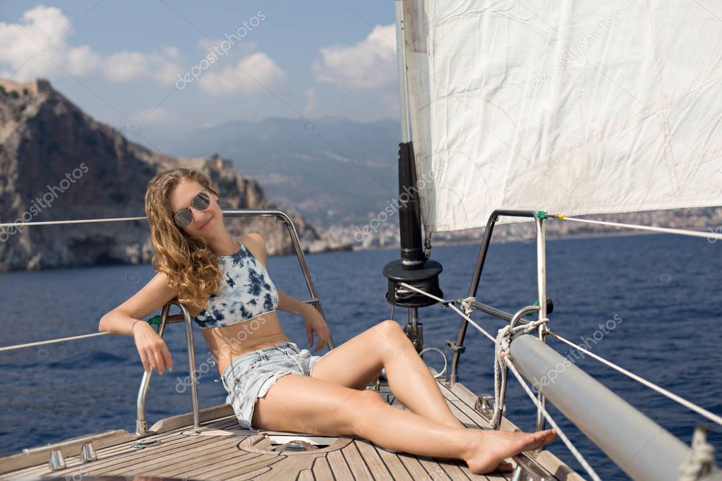 Young blonde woman enjoying sailing 