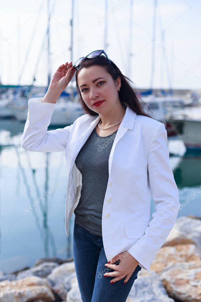 Portrait of woman dressed in nautical style in yacht marina