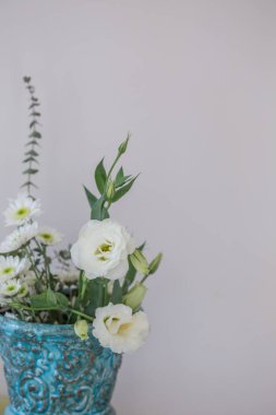 Dikey çekim vintage turkuaz Vazoda beyaz lisianthus, kopya alanı ile alan sığ derinliği ile