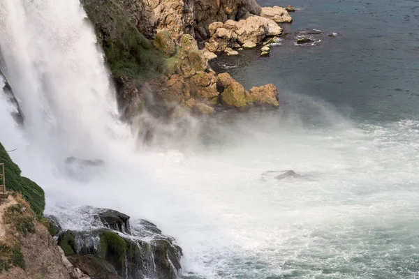 Horizontal landscape with beautiful waterfall falling into the sea.