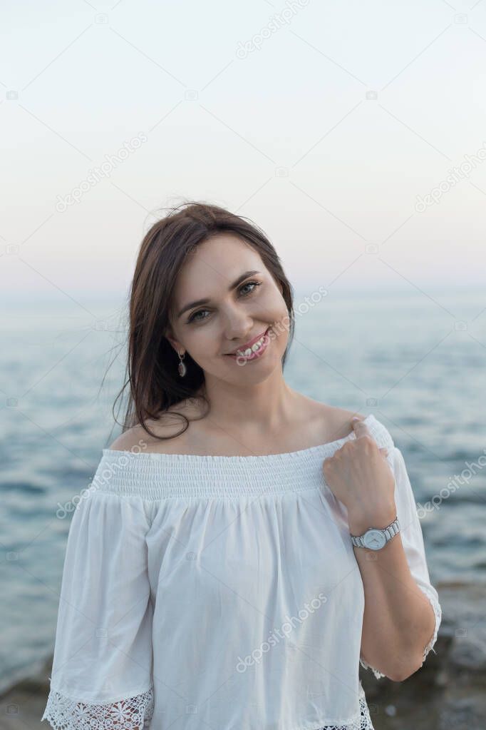 Portrait of a beautiful young woman by seaside