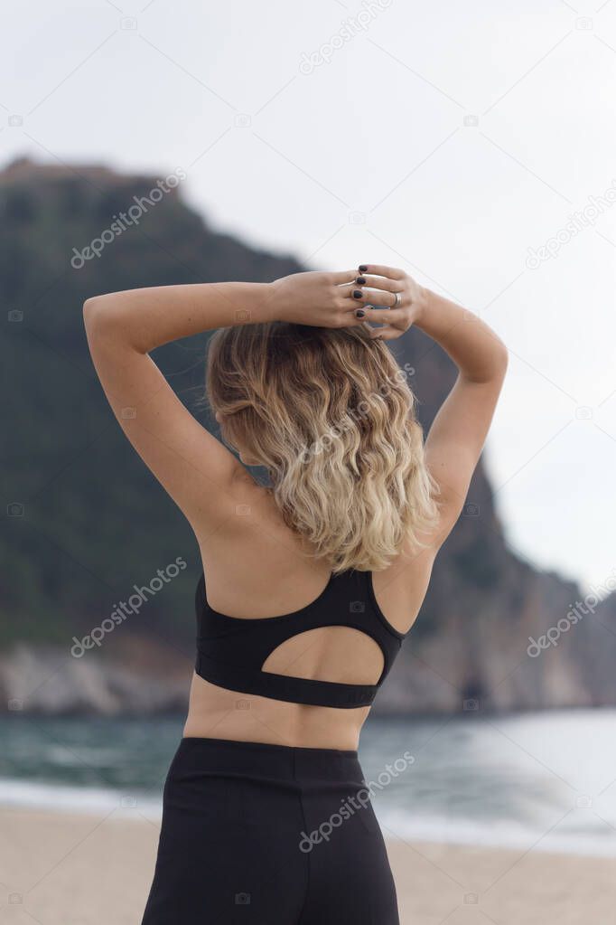 Fitness concept. Backview portrait of a fit female in black outf