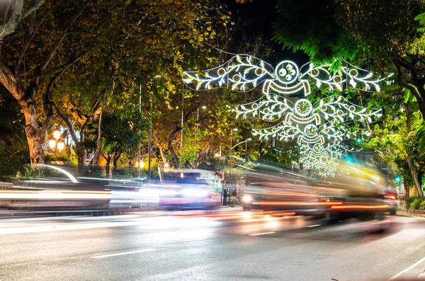 a busy night filled with lights leading up to christmas on my local high street in Marbella, Spain