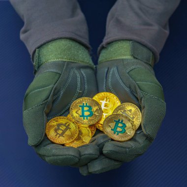 cryptocurrency yeşil bitcoin ile holding eller altın sikke üzerinde oturum.