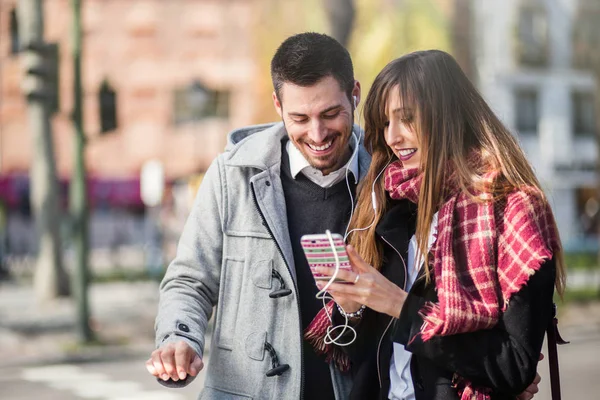 Pasangan menggunakan telepon di jalan — Stok Foto