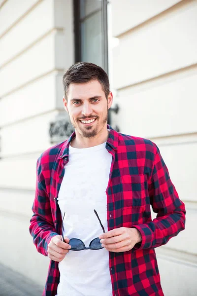 Portrait of young cheerful attractive man outdoors Stock Photo