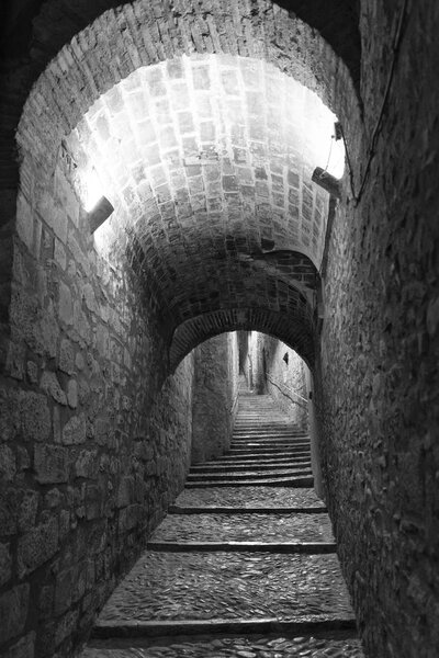 Girona (Gerona, Catalunya, Spain): old typical street by night. Black and white