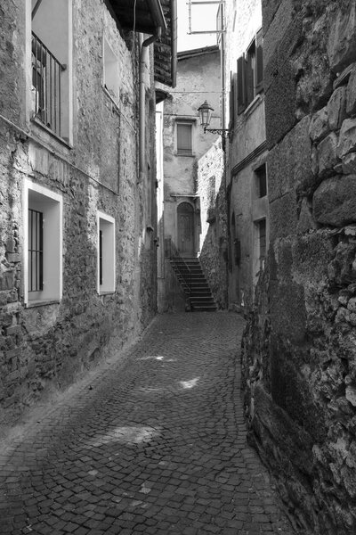 Asso (Como, Lombardy, Italy): typical street in the historic town. Black and white