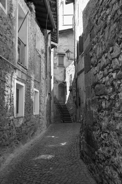 Asso (Como, Lombardy, Italy): typical street in the historic town. Black and white