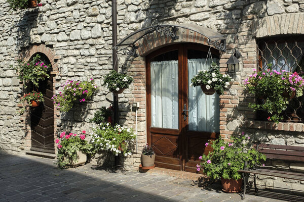 Nibbiano (Piacenza, Emilia-Romagna, Italy): old typical house exterior with plants, and flowers