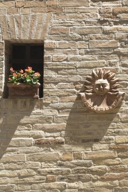 Monte Giberto, Fermo, Marches, Italy: medieval village. Typical building with potted flowers