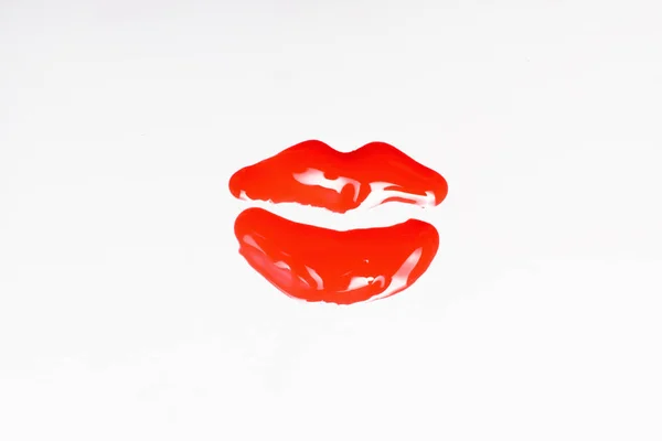 Red shiny lip imprint isolated on white background