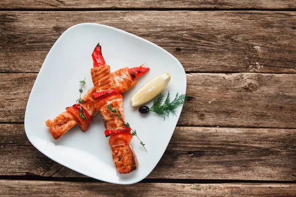 Delicious salmon kebab served on wood free space — Stock Photo, Image