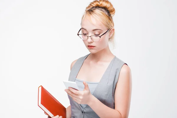Young blonde in glasses addicted to smartphone. — Stock Photo, Image