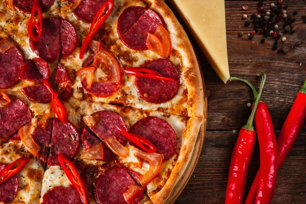 Pepperoni pizza served on rustic wooden table