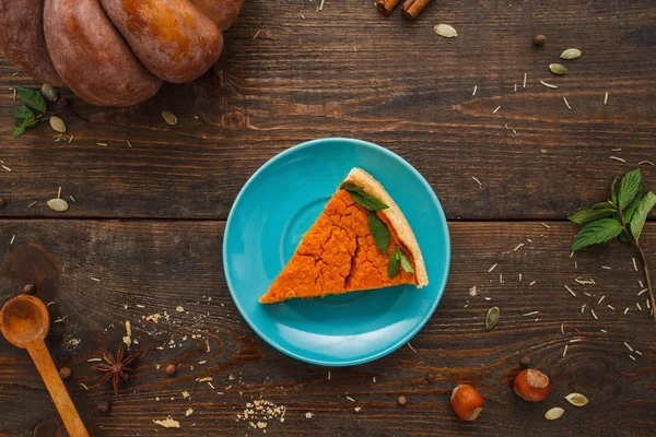 Piece of pumpkin tart on blue saucer flat lay — Stock Photo, Image
