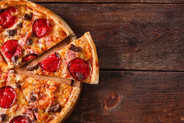 Italian pizza served on wooden table, free space