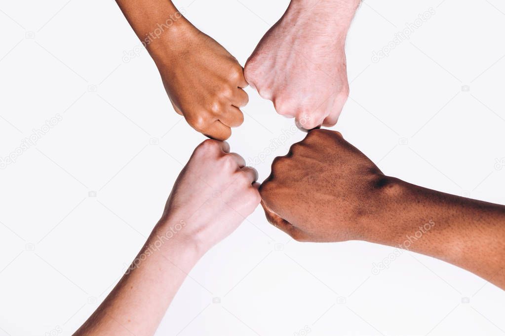 Interracial friend, white and black hands together