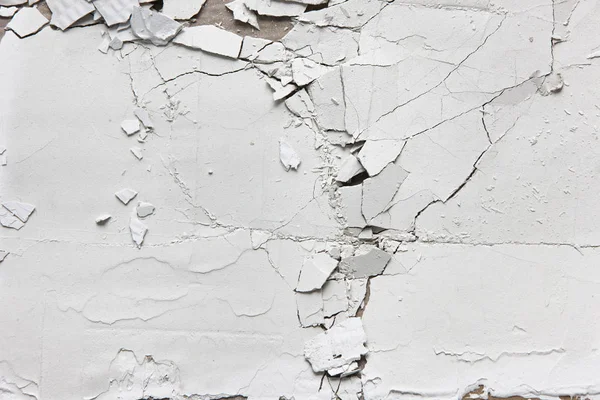 White cracked split wall, old plaster peel texture