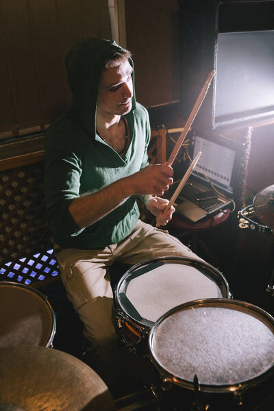 Drummer playing drums in recording studio
