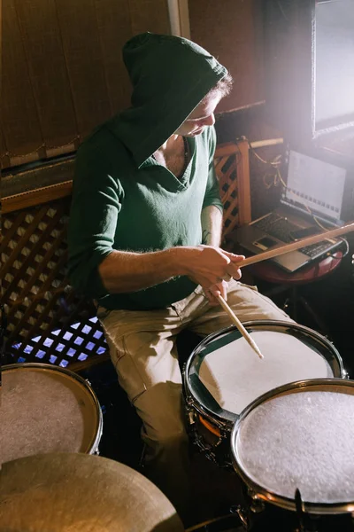Drummer recording drums in music studio