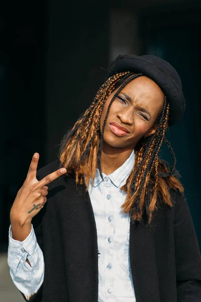 Victory gesture. Confident young black lady