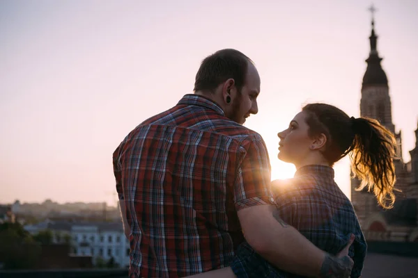 Romantic couple on roof in focus on foreground — Stock Photo, Image