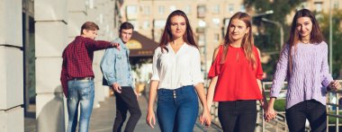 Grup genç adamın şehirde kadın ile flört.