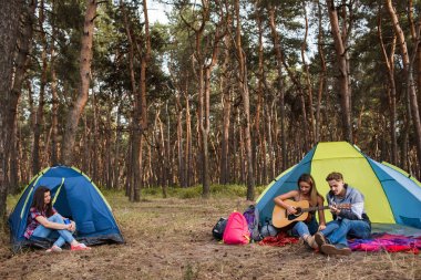 Arkadaşlar gitar müziği dinleyin. Turistik dinlenme niteliğine.