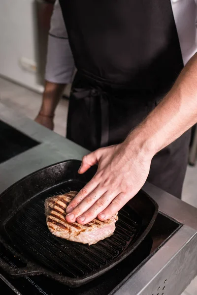 Chef works restaurant kitchen preparing meat — Stock Photo, Image