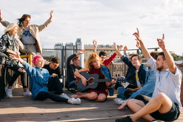 exchange students singing rooftop together bonding