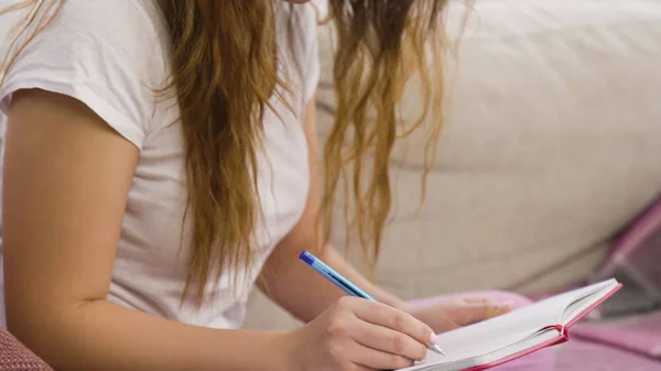 Relaxed studying casual girl sitting home writing — Stock Photo, Image