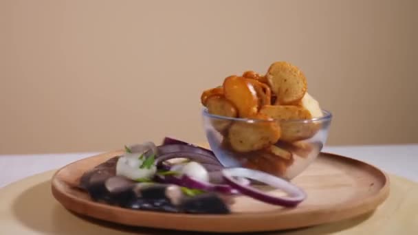 Galletas de pan sabrosas en un plato con pescado salado y cebolla — Vídeo de stock