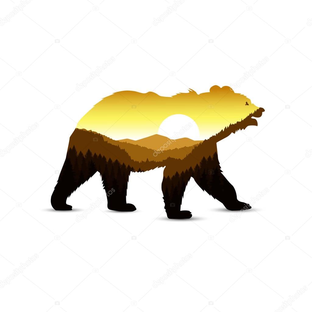 Silhouette of bear with mountain landscape.