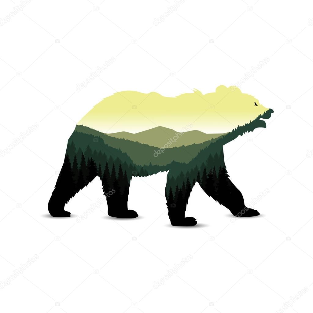 Silhouette of bear with mountain landscape.