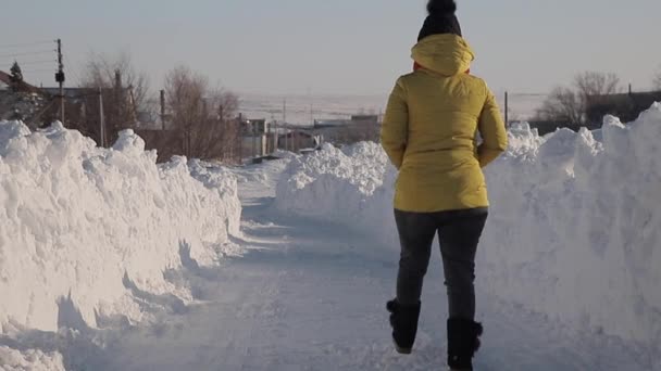 Girl Walks Road Large Snow Drifts — Stock Video