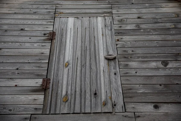 Old wooden barn door. gray wood plank texture