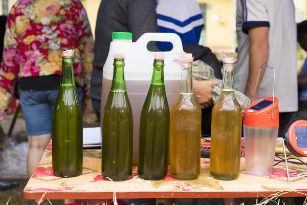 Bottles of bees honey displayed for selling in mountainous road of Vietnam