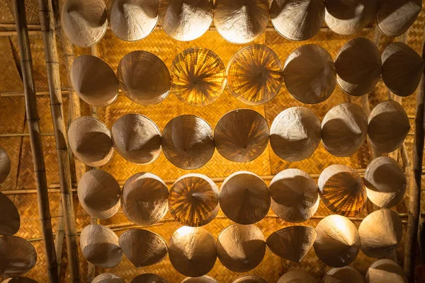 Bottom view of Vietnamese conical hats hanging on cell