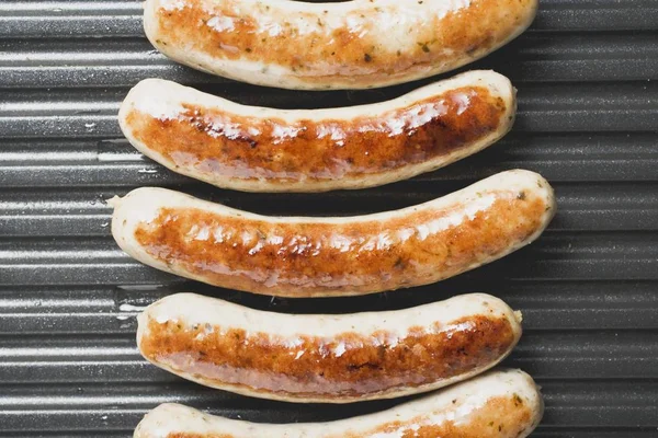 Fresh sausages on grill — Stock Photo, Image