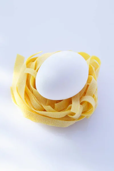 Fresh egg on tagliatelle — Stock Photo, Image