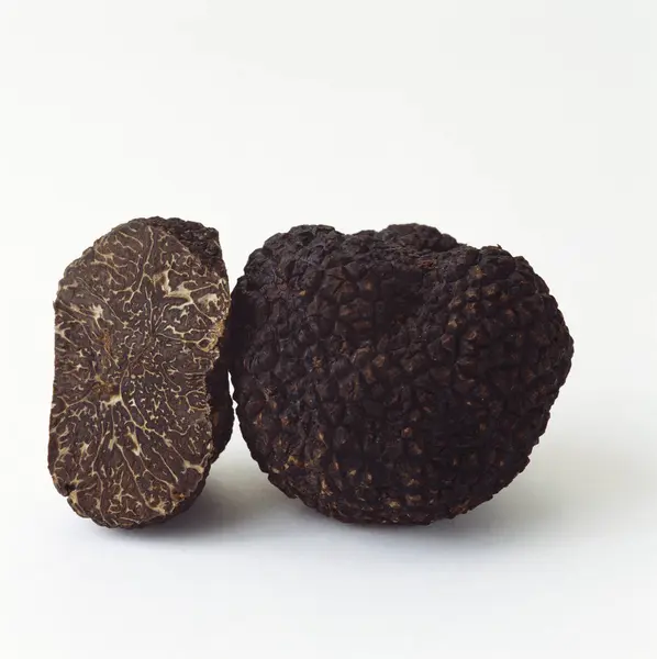Whole and half black truffle — Stock Photo, Image