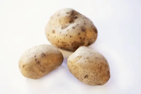 Three fresh and washed potatoes — Stock Photo, Image