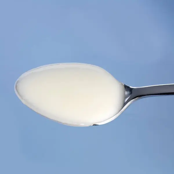 Spoonful of natural yoghurt — Stock Photo, Image